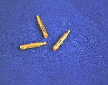 micro parts made on a milling machine next to a ruler